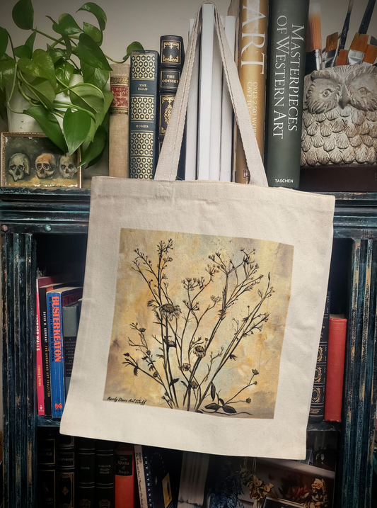 Beige tote bag with floral design on a bookshelf background